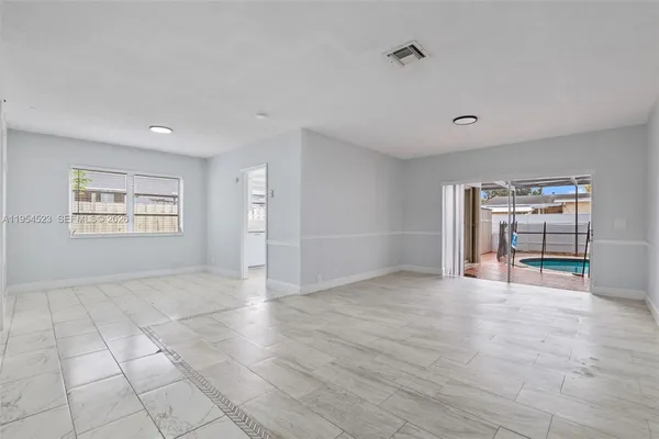 a view of an empty room with a window
