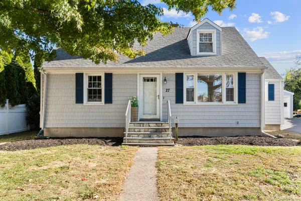 a front view of a house with a yard