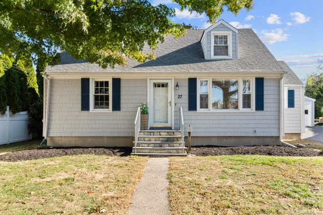 a front view of a house with a yard