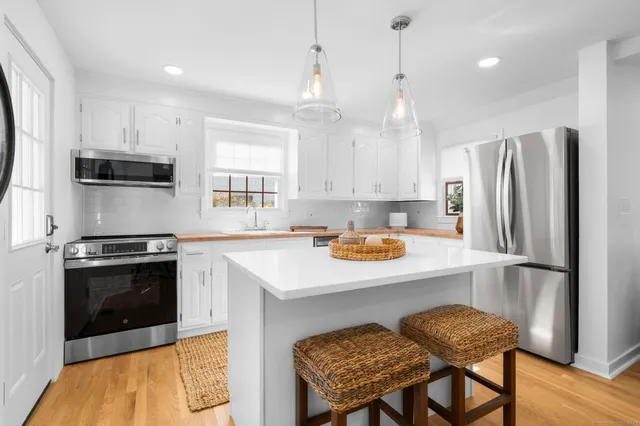 a kitchen with a refrigerator a stove a sink and a center island