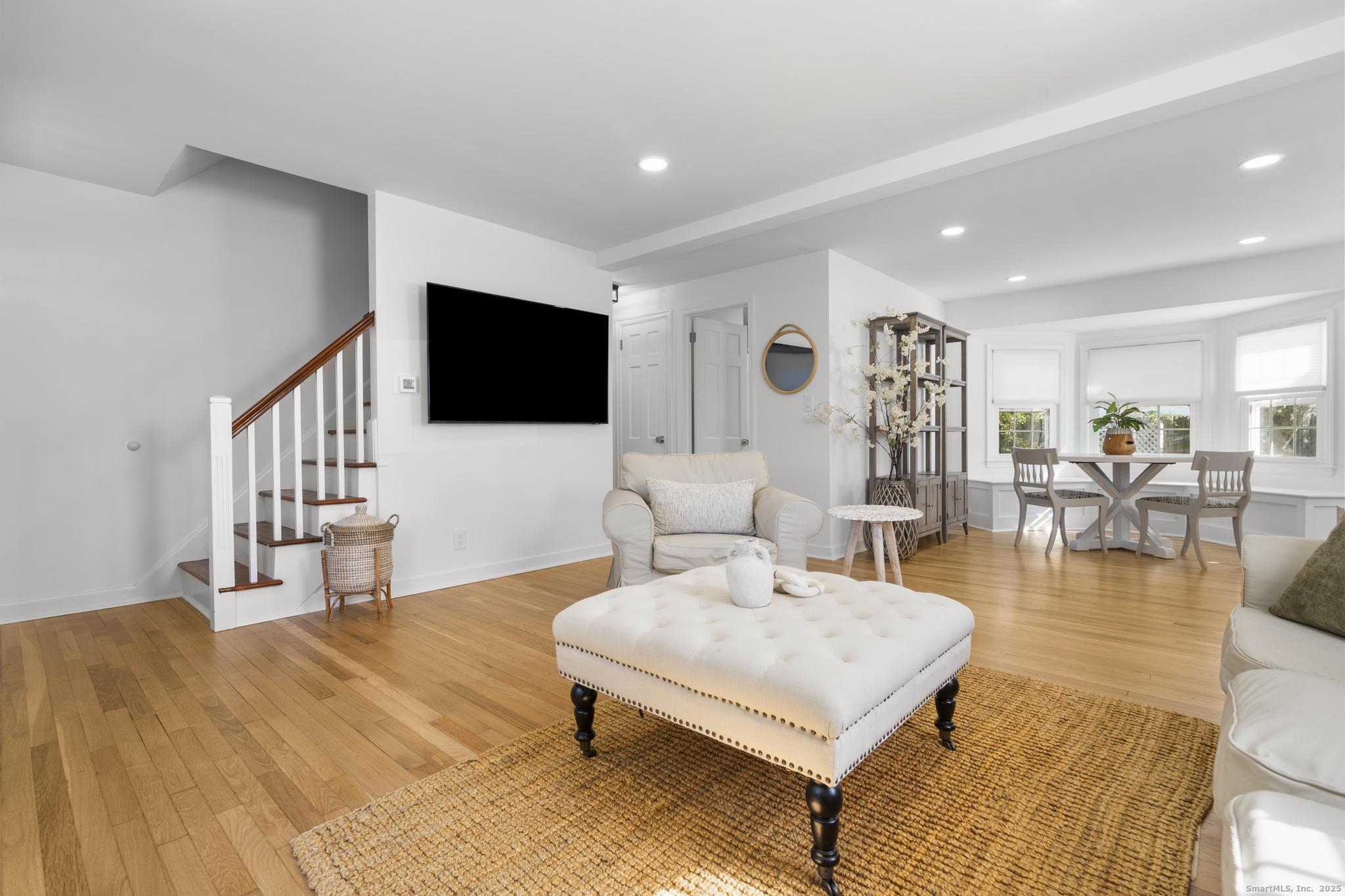 27 Reef Court Fairfield, CT 06824 - Photo 17 of 23 a living room with furniture and a flat screen tv