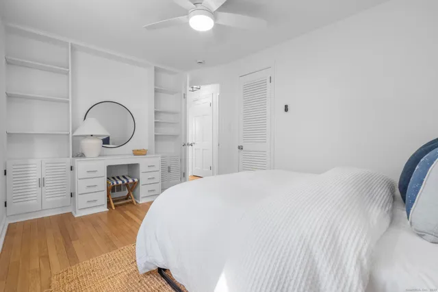 a spacious bedroom with a bed and a dresser