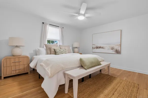 a bedroom with a bed and wooden floor