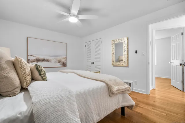 a bedroom with bed and a chandelier