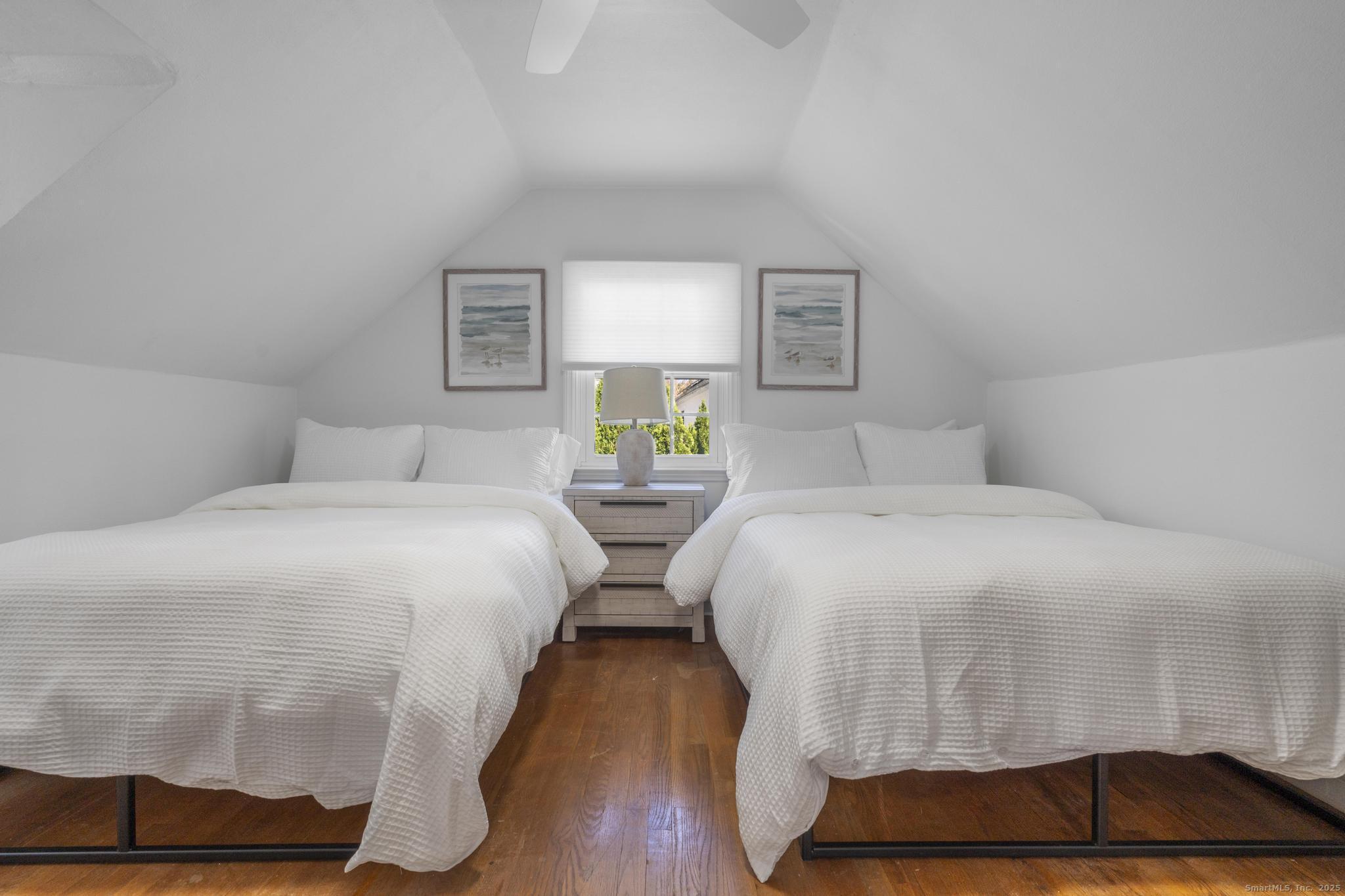 27 Reef Court Fairfield, CT 06824 - Photo 23 of 23 a bedroom with a bed and wooden floor