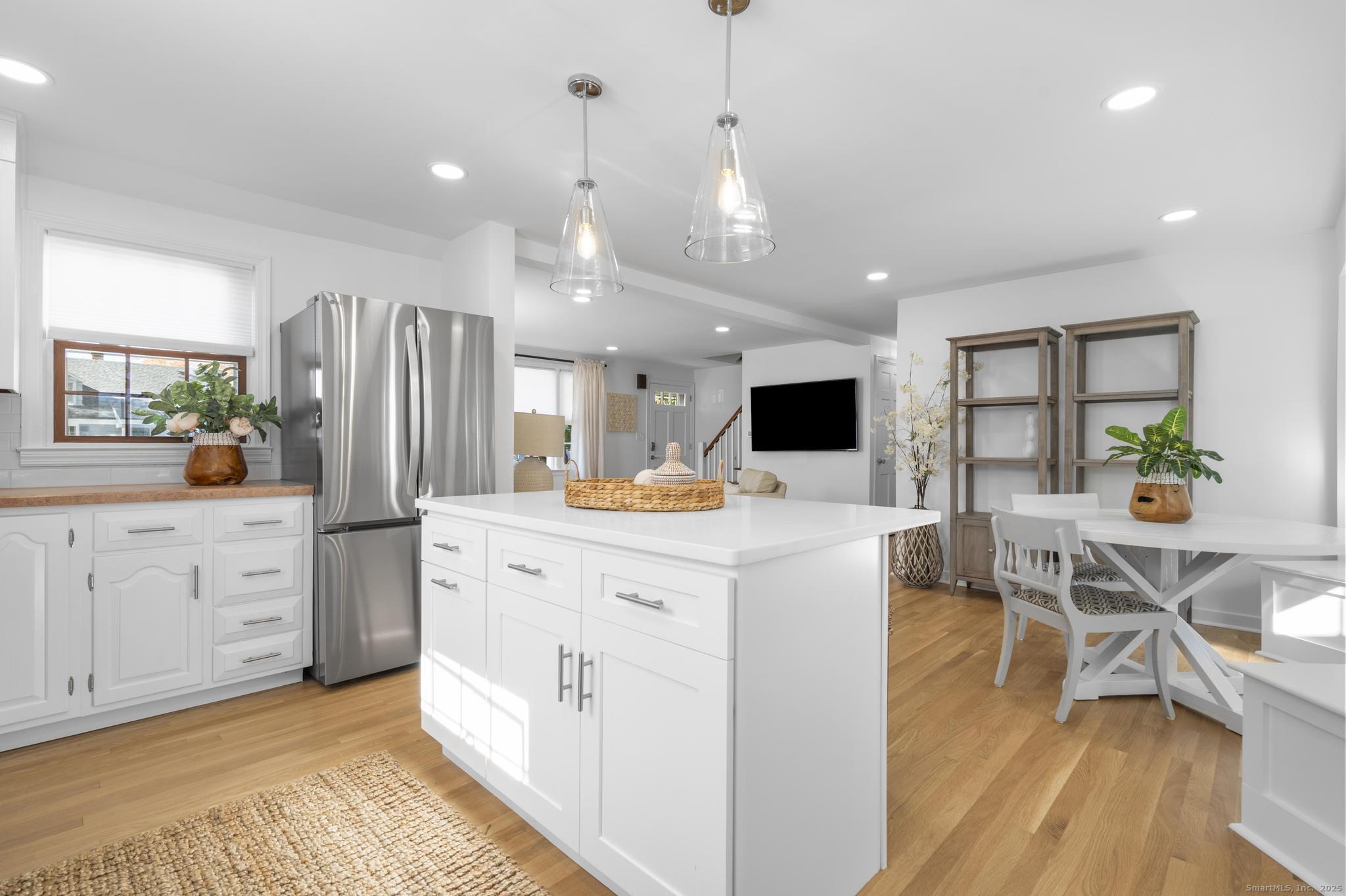 27 Reef Court Fairfield, CT 06824 - Photo 3 of 23 a large white kitchen with lots of counter space and stainless steel appliances