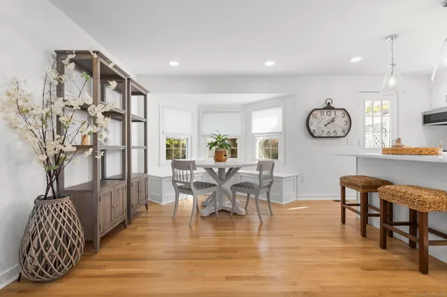a view of dining room and livingroom with furniture wooden floor and a rug