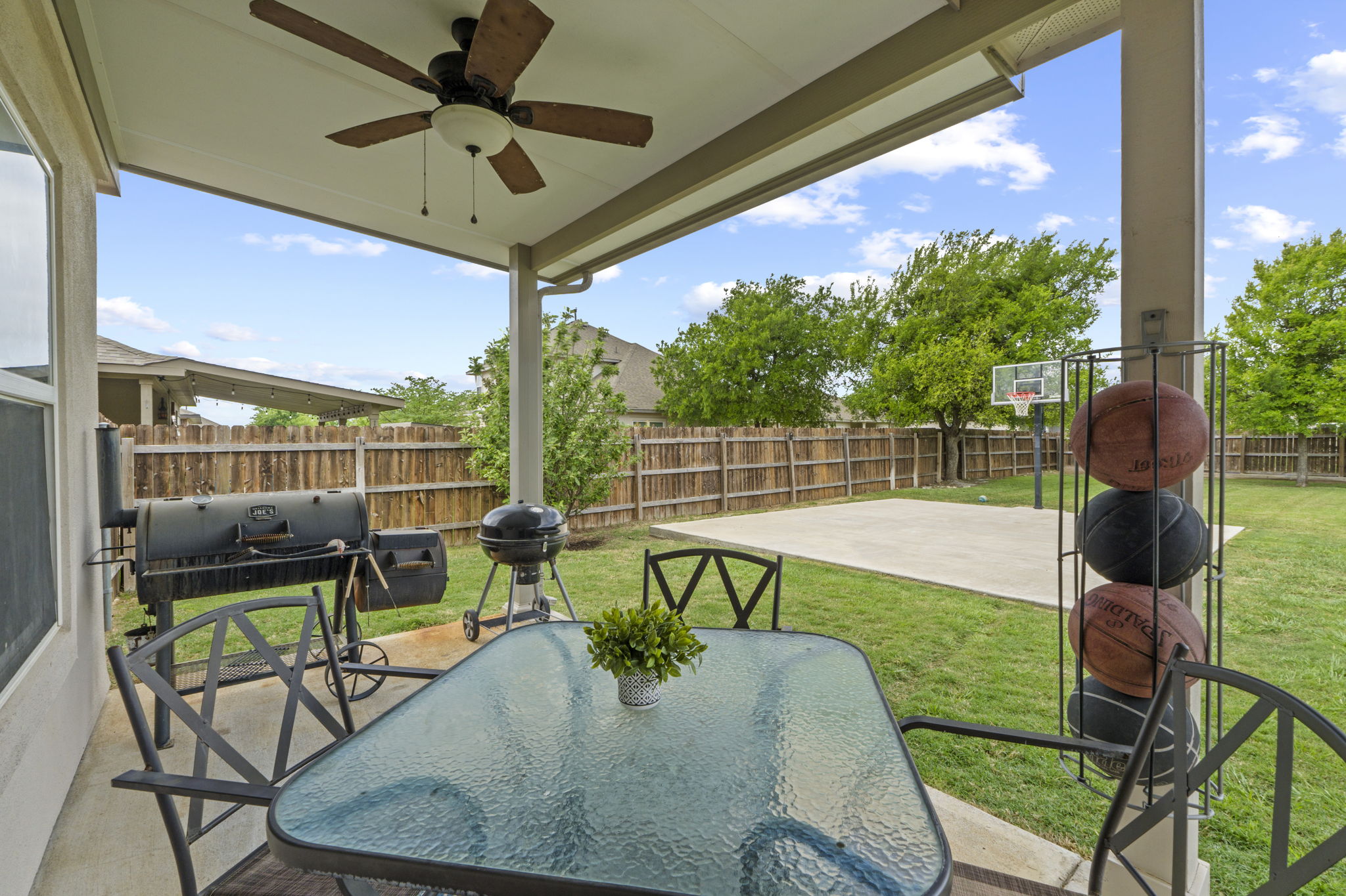 2417 Bridges Ranch Road Georgetown, TX 78628 - Photo 15 of 36 Fenced backyard featuring a patio, a ceiling fan, outdoor dining area, and grilling area