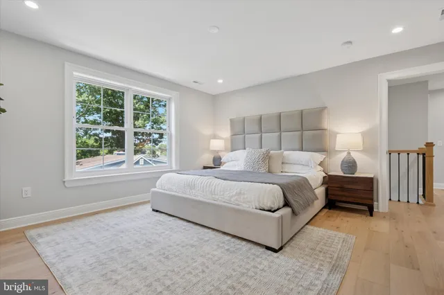 a bedroom with a large bed and a large window