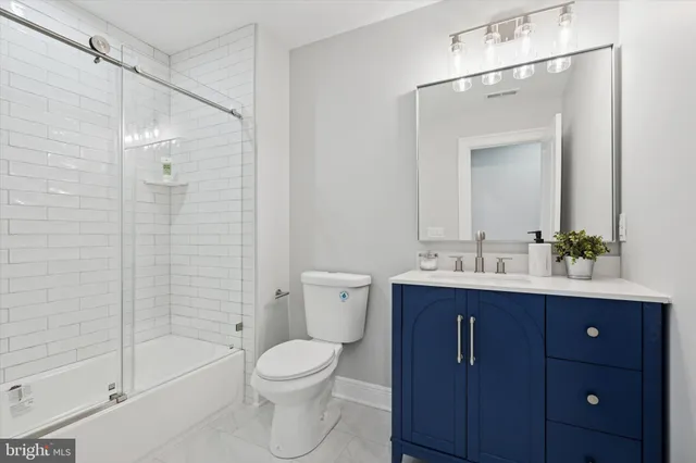 a bathroom with a toilet a sink a mirror a bathtub and shower