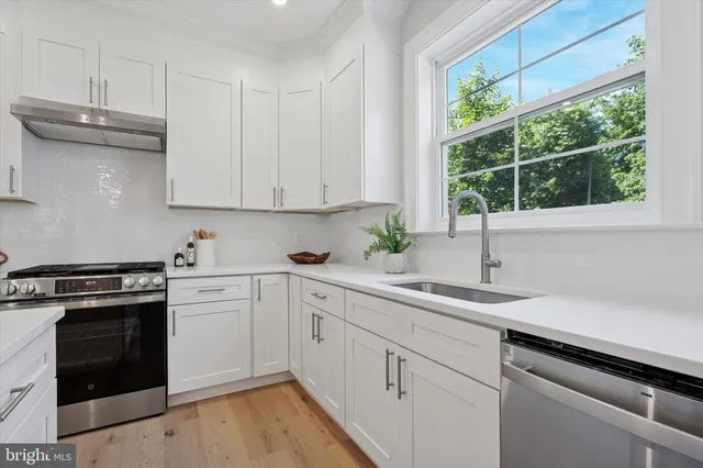 a kitchen with a sink stove and cabinets