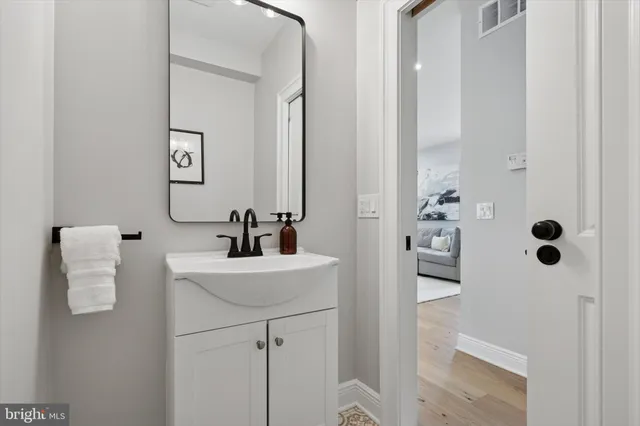 a bathroom with a sink a mirror and shower