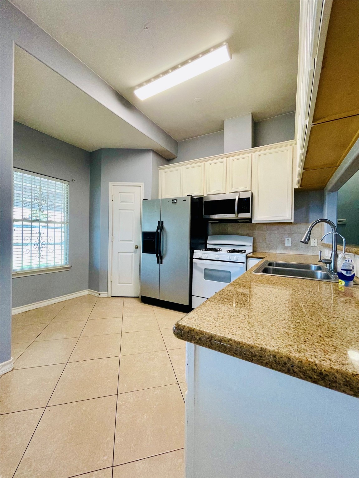 13739 Canyon Hollow Loop Houston, TX 77083 - Photo 12 of 14 a kitchen with stainless steel appliances granite countertop a sink refrigerator and cabinets