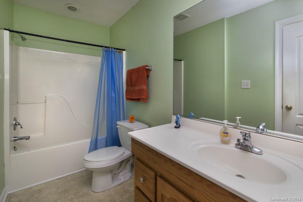 146 State Park Road Troutman, NC 28166 - Photo 12 of 18 a bathroom with a sink and a mirror