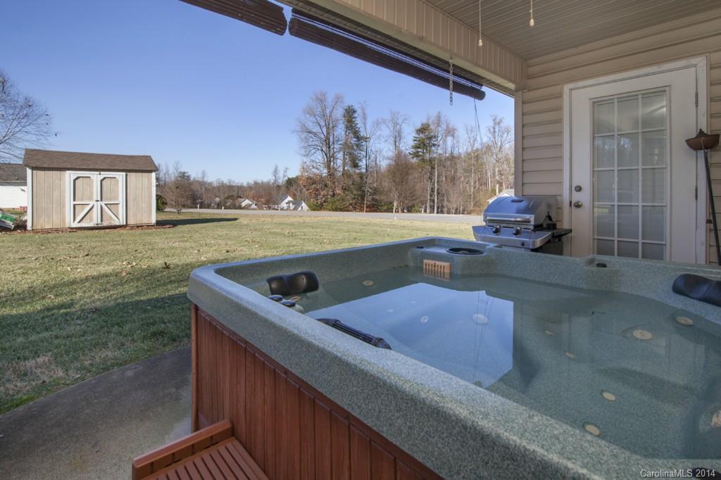 146 State Park Road Troutman, NC 28166 - Photo 14 of 18 a view of a house with a backyard and a tub