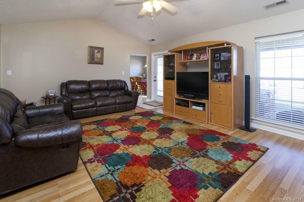146 State Park Road Troutman, NC 28166 - Photo 3 of 18 a living room with a couch and a flat screen tv