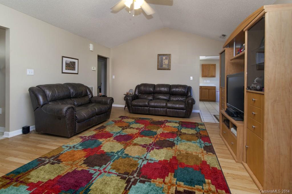 146 State Park Road Troutman, NC 28166 - Photo 4 of 18 a living room with furniture and a flat screen tv