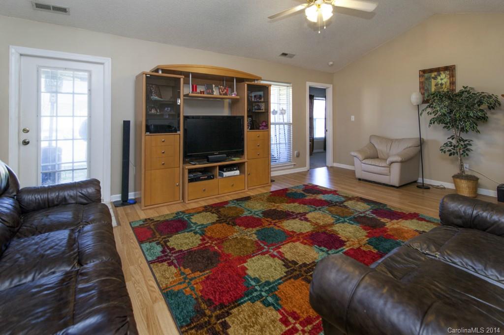 146 State Park Road Troutman, NC 28166 - Photo 5 of 18 a living room with a couch and a flat screen tv