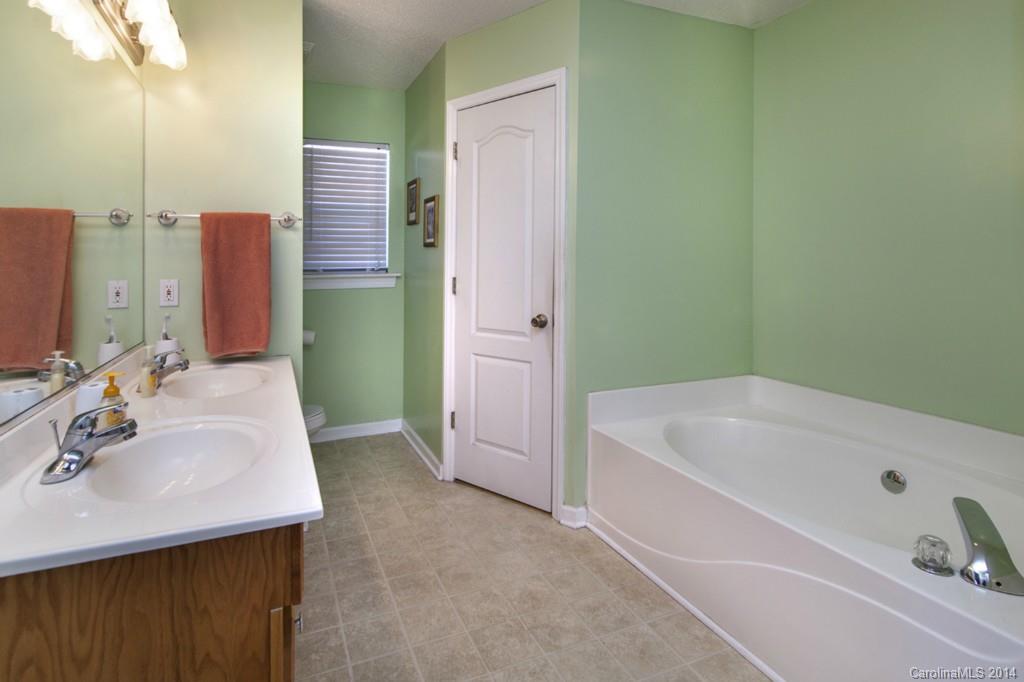 146 State Park Road Troutman, NC 28166 - Photo 10 of 18 a bathroom with a bathtub sink and mirror