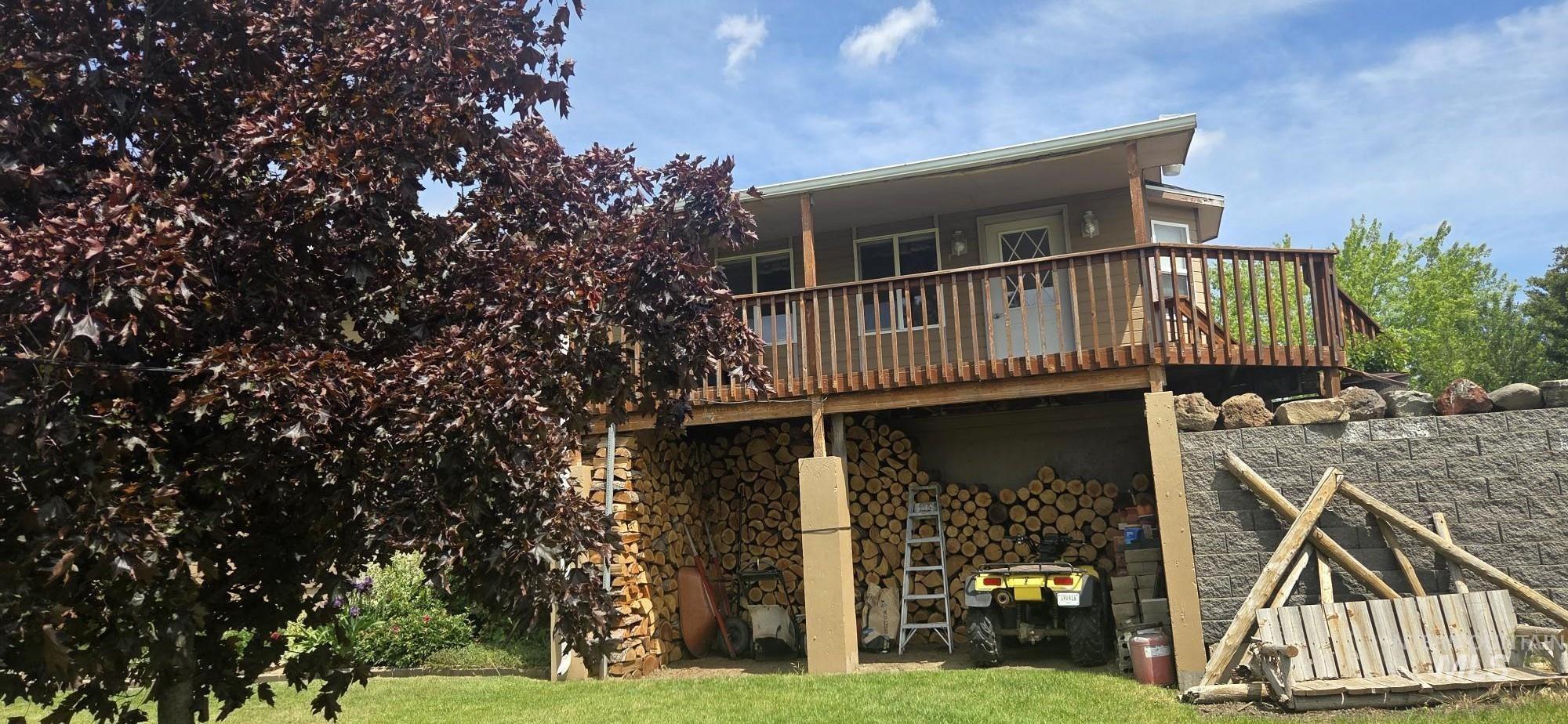 394 Substation Road Cottonwood, ID 83522 - Photo 6 of 37 Elevated outdoor deck with wood railing, recessed lighting, and a partial roofline