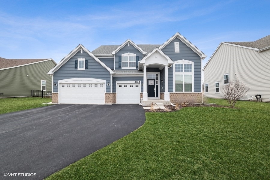 a view of a house with a yard and garage