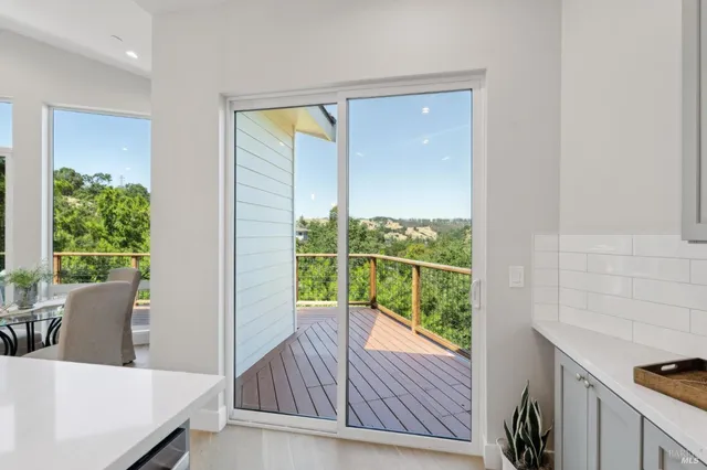 a balcony with wooden floor and outdoor seating