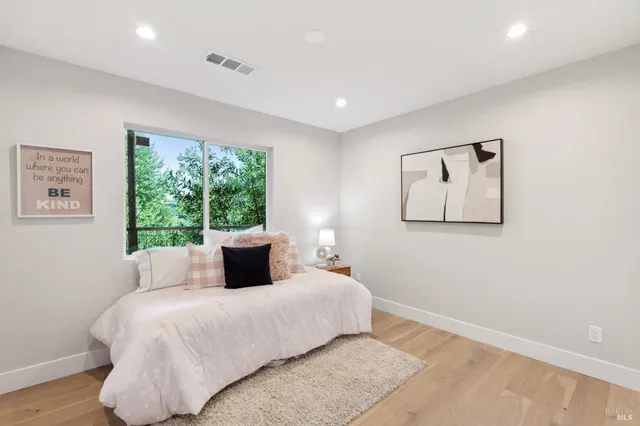 a bedroom with a bed and a window