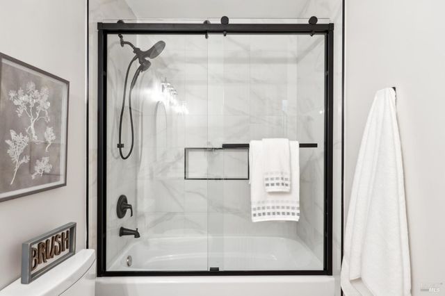 a view of a hallway with wooden floor and closet