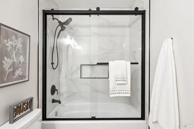 a view of a hallway with wooden floor and closet