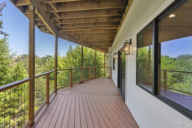an aerial view of residential houses with outdoor space and trees