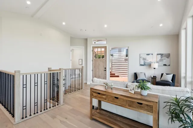 a living room with furniture and large windows