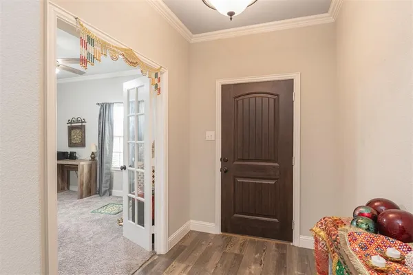 a view of a hallway with wooden floor and closet