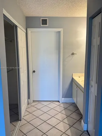 a view of a room with wooden floor and door