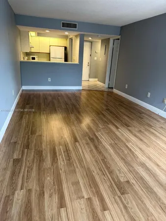 a kitchen with stainless steel appliances kitchen island a refrigerator sink and stove