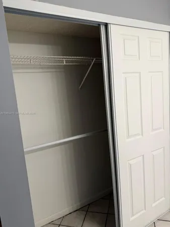 a view of a livingroom with wooden floor and a ceiling fan