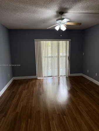a bathroom with a granite countertop bathtub shower and toilet