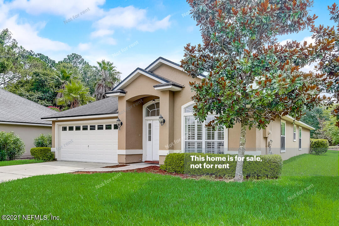608 Birchbark Trail St. Augustine, FL 32092 - Photo 11 of 35 a front view of a house with a garden and yard
