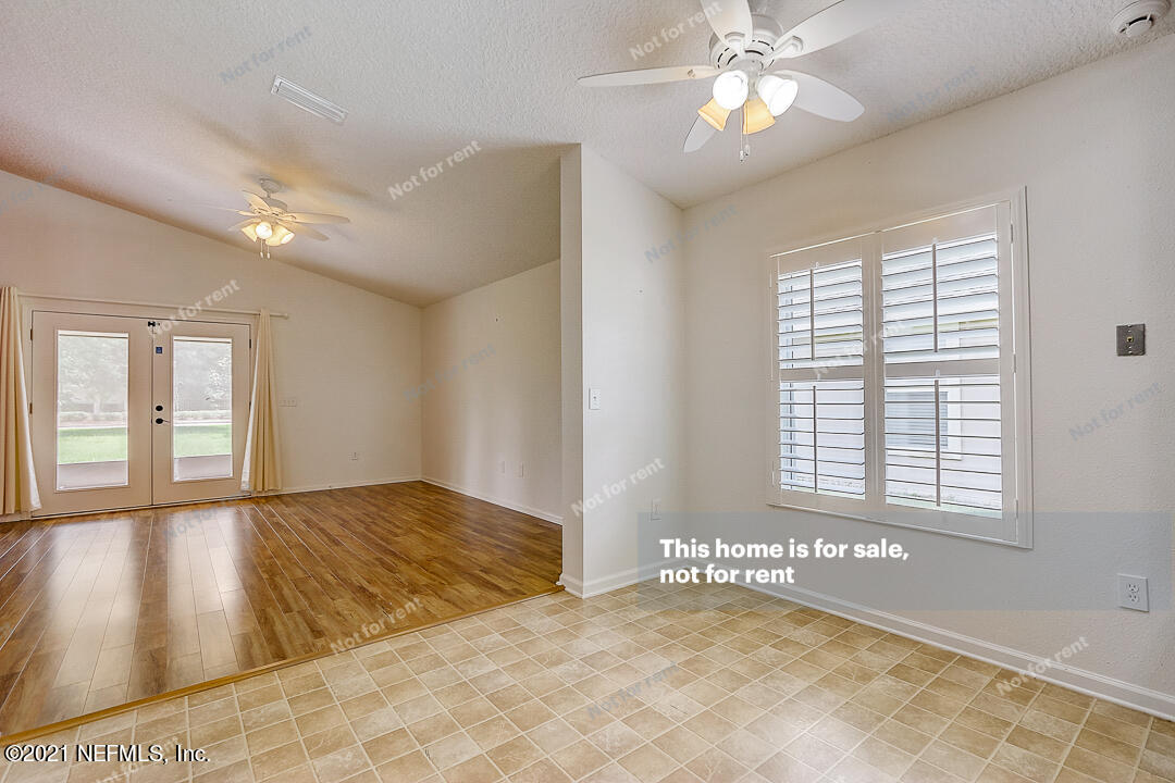 608 Birchbark Trail St. Augustine, FL 32092 - Photo 19 of 35 a view of an empty room with window and chandelier fan