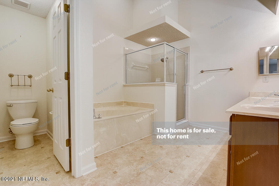 608 Birchbark Trail St. Augustine, FL 32092 - Photo 21 of 35 a bathroom with a granite countertop sink a toilet and shower