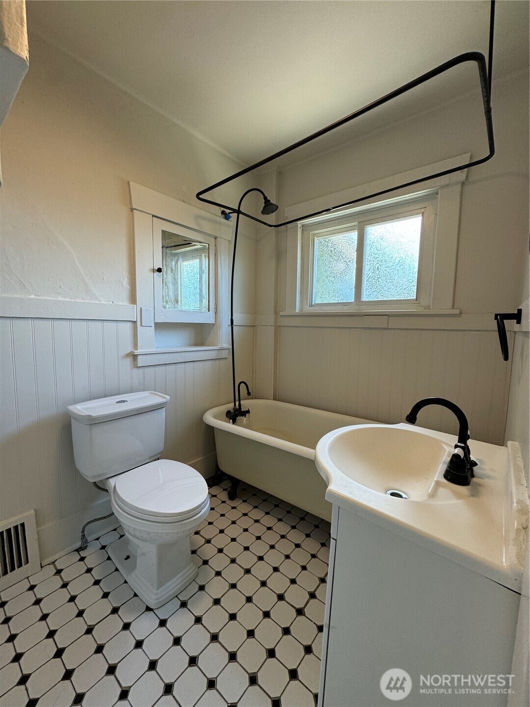 811 Northeast 66th Street Seattle, WA 98115 - Photo 14 of 36 a bathroom with a sink toilet a mirror and shower