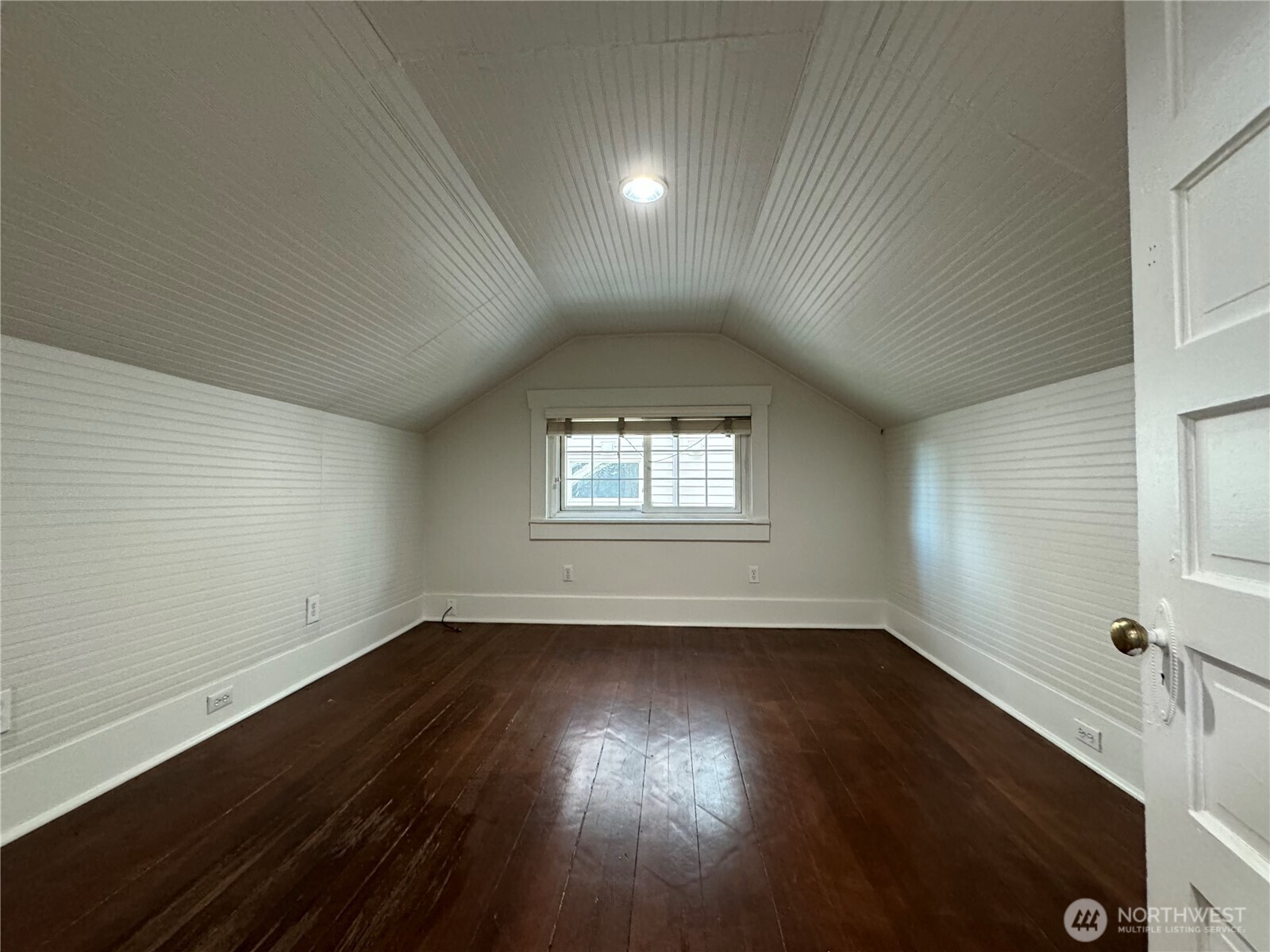 811 Northeast 66th Street Seattle, WA 98115 - Photo 16 of 36 an empty room with wooden floor and windows