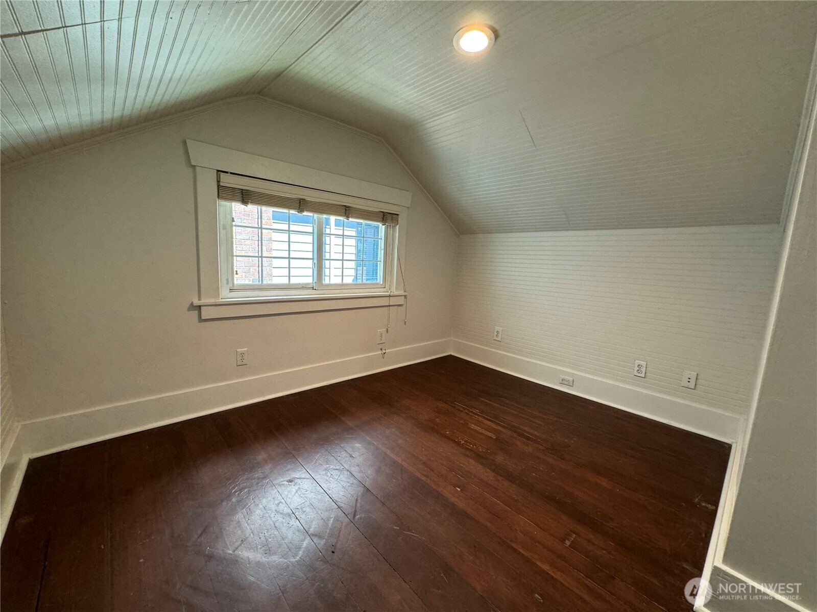 811 Northeast 66th Street Seattle, WA 98115 - Photo 17 of 36 an empty room with wooden floor and windows