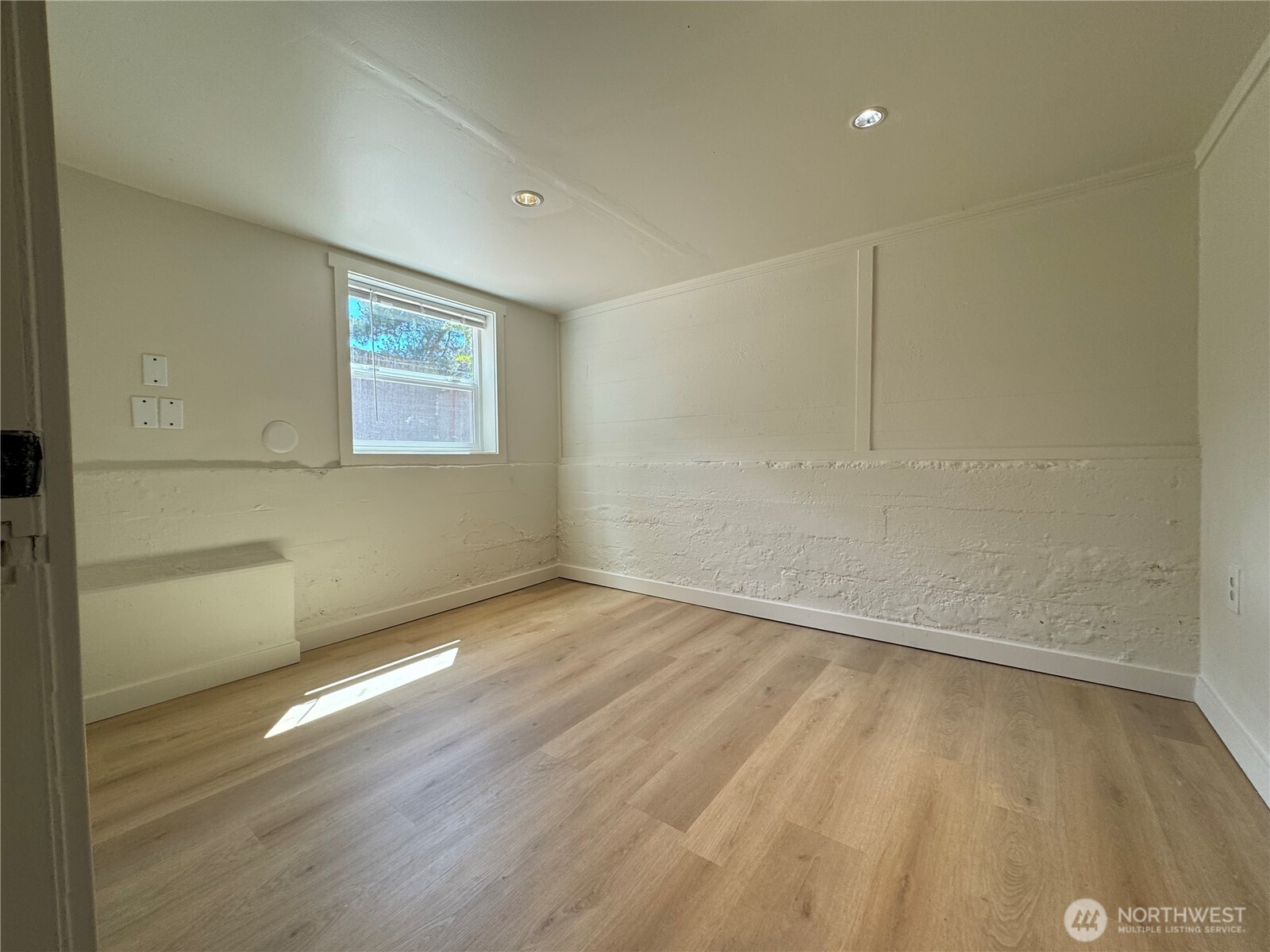 811 Northeast 66th Street Seattle, WA 98115 - Photo 19 of 36 an empty room with wooden floor and windows