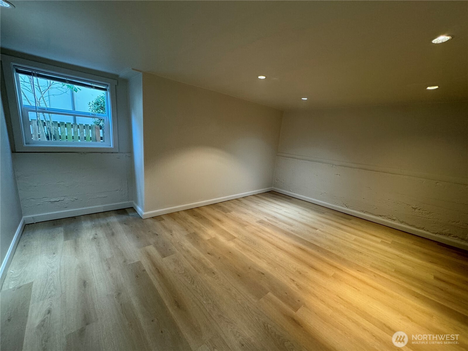 811 Northeast 66th Street Seattle, WA 98115 - Photo 20 of 36 an empty room with wooden floor and windows