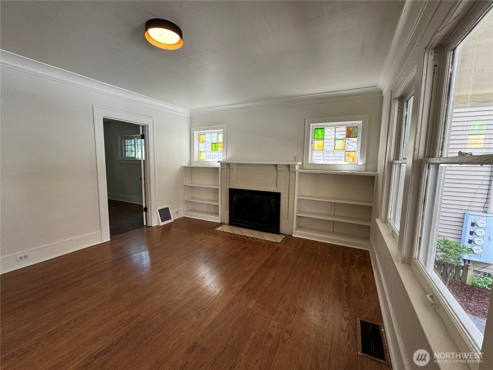 811 Northeast 66th Street Seattle, WA 98115 - Photo 5 of 36 wooden floor in an empty room with a window