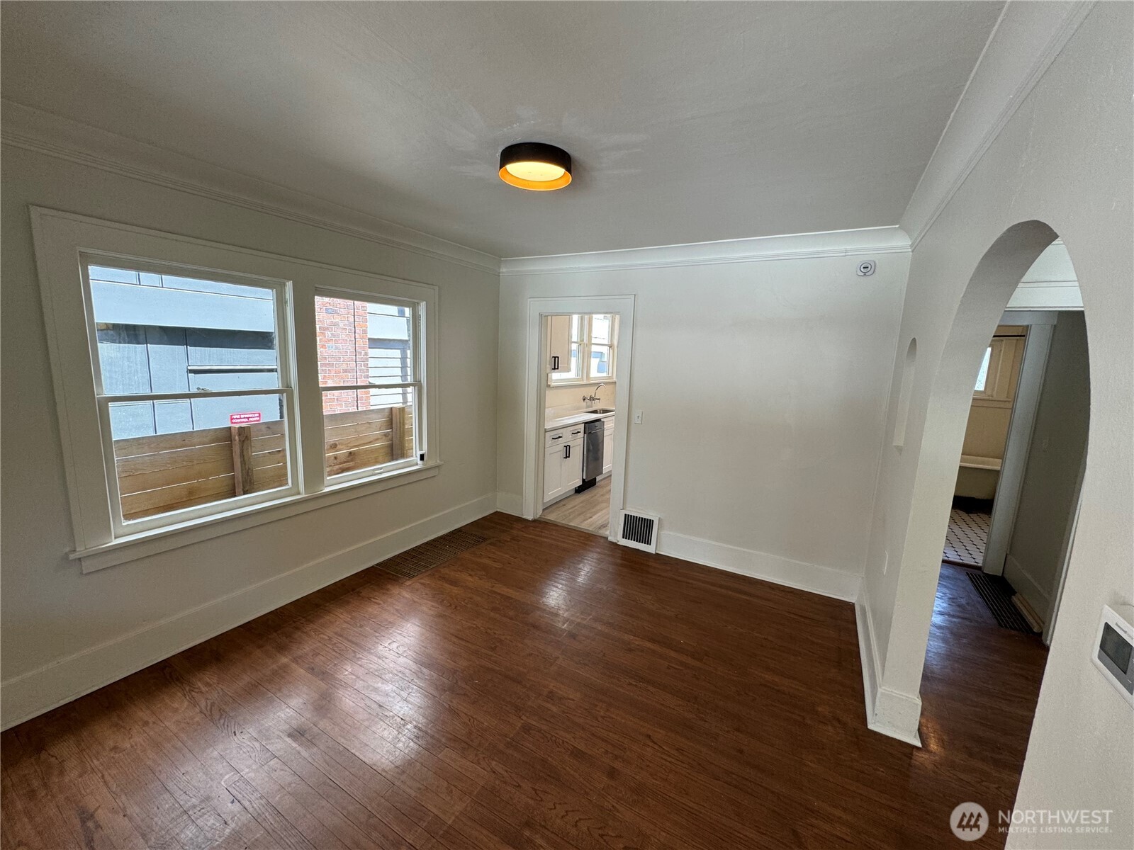 811 Northeast 66th Street Seattle, WA 98115 - Photo 8 of 36 an empty room with wooden floor and windows