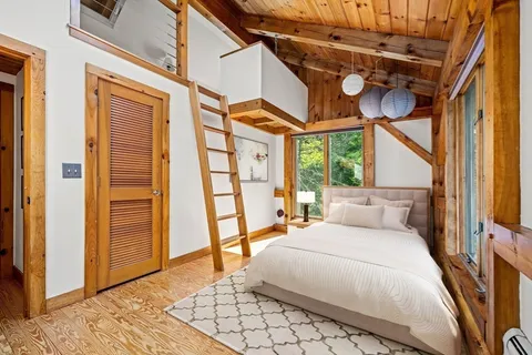 a bedroom with a bed and a large window
