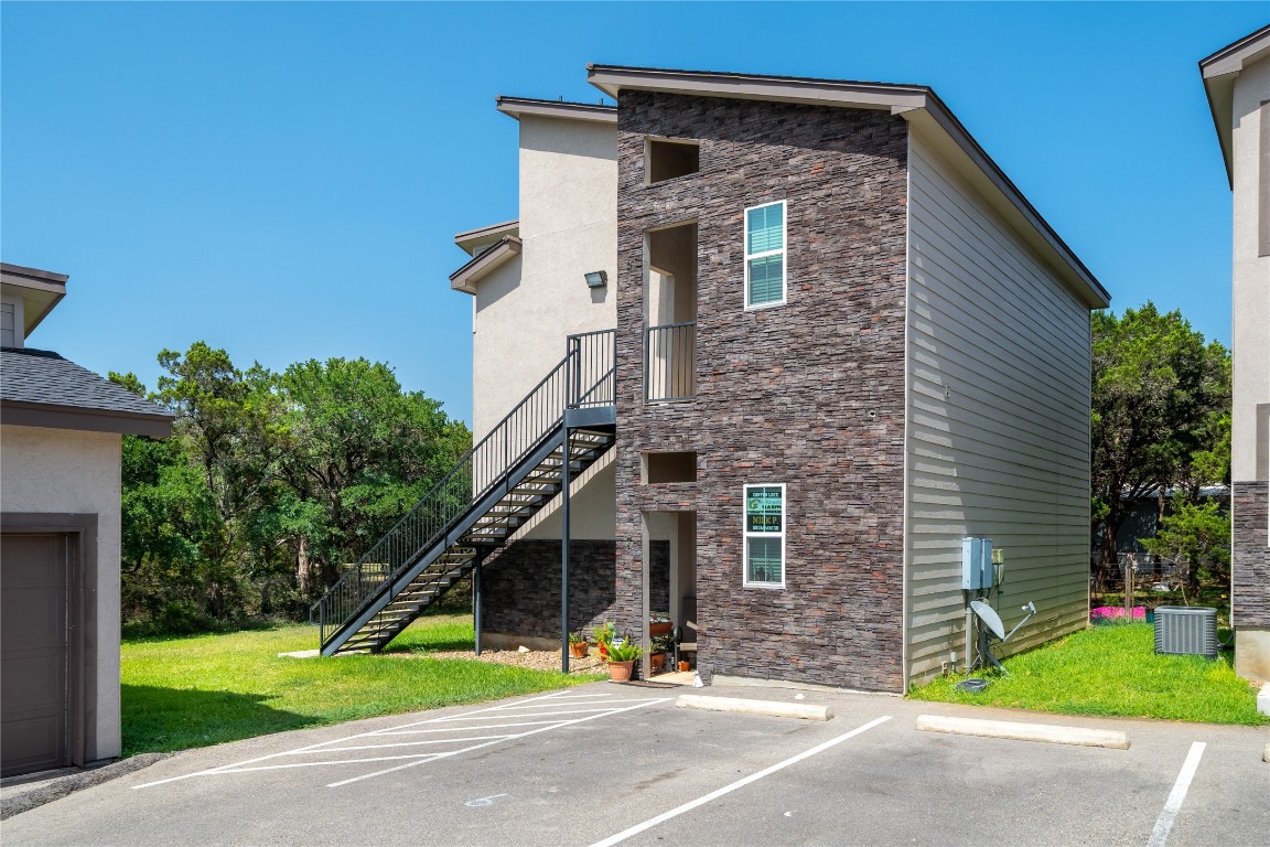 3067 View Ridge Drive, Unit 1 Spring Branch, TX 78070 - Photo 1 of 17 a view of a brick house with a yard