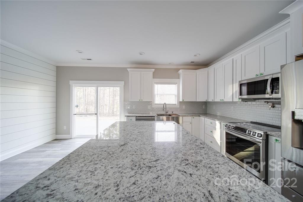 578 Crescent Road Salisbury, NC 28146 - Photo 30 of 41 a large kitchen with white cabinets and stainless steel appliances