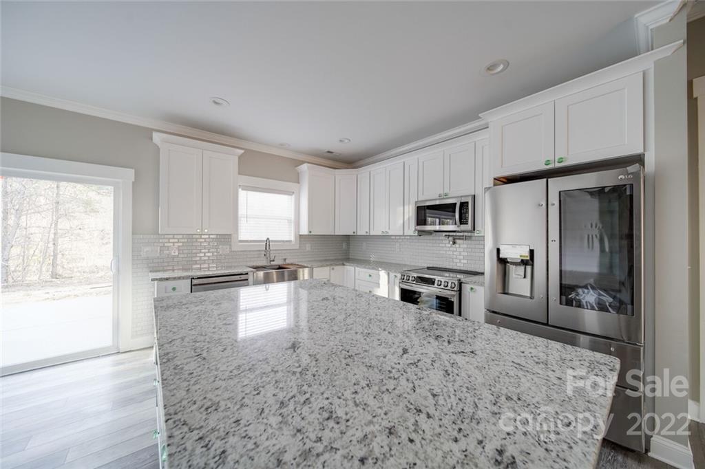 578 Crescent Road Salisbury, NC 28146 - Photo 31 of 41 a kitchen with granite countertop a refrigerator stove and oven